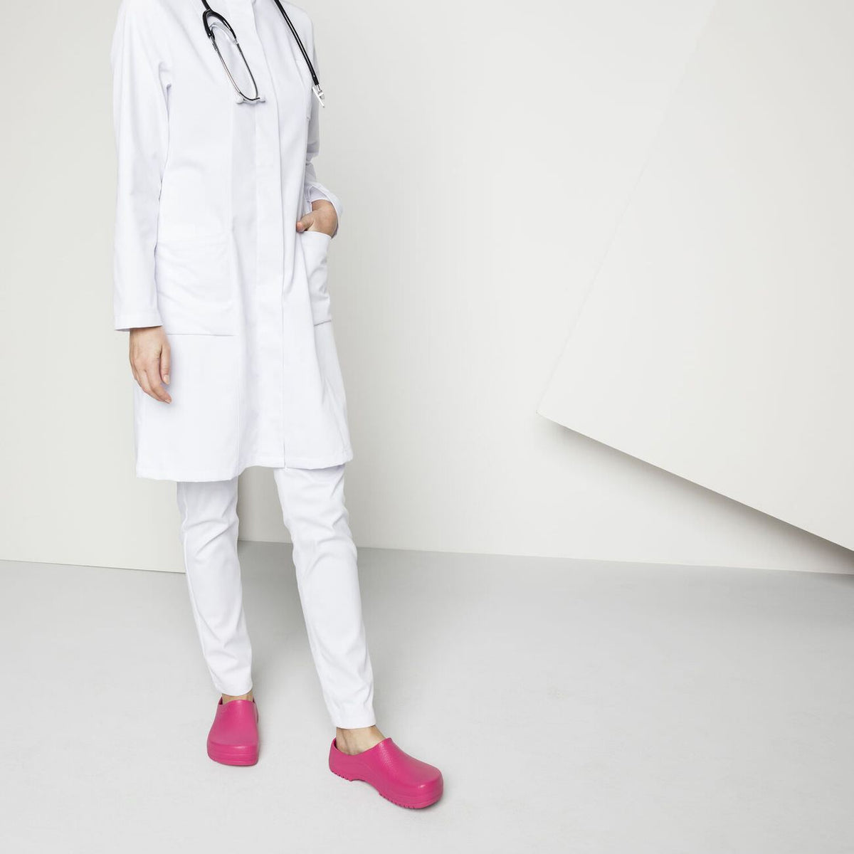 Birkenstock Super Birki Raspberry Worn by a lady in a white coat and white pants on a white background